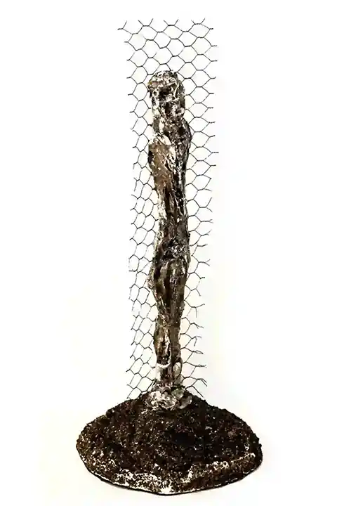 Sculpture of a man with his back to the wall, dimensions 35x14x14 cm, mixed technique.